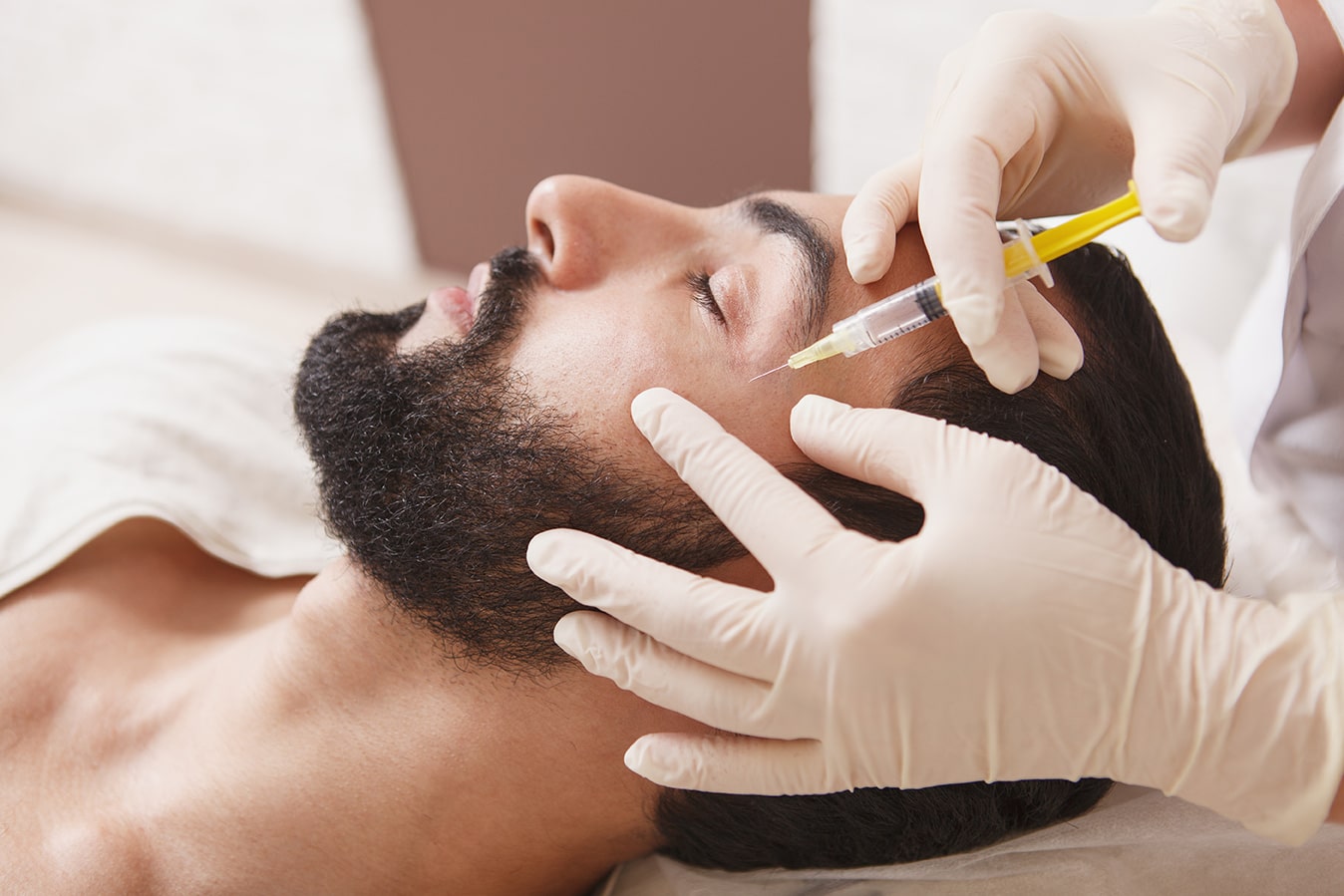 Bearded man getting anti-wrinkle face filler treatment at Halo Skin Institute in rocklin california